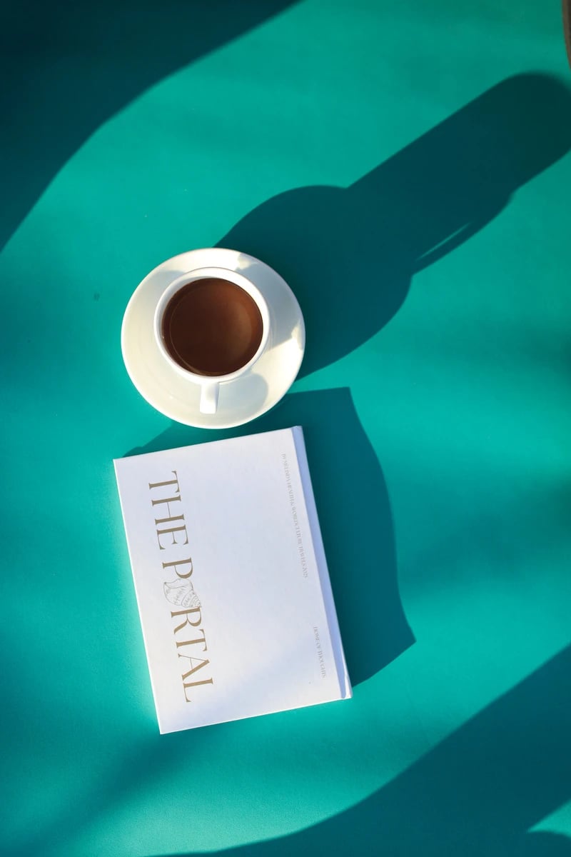 Das Portal-Workbook und eine Tasse türkischer Kaffee auf türkisfarbenem Untergrund im Sonnenlicht